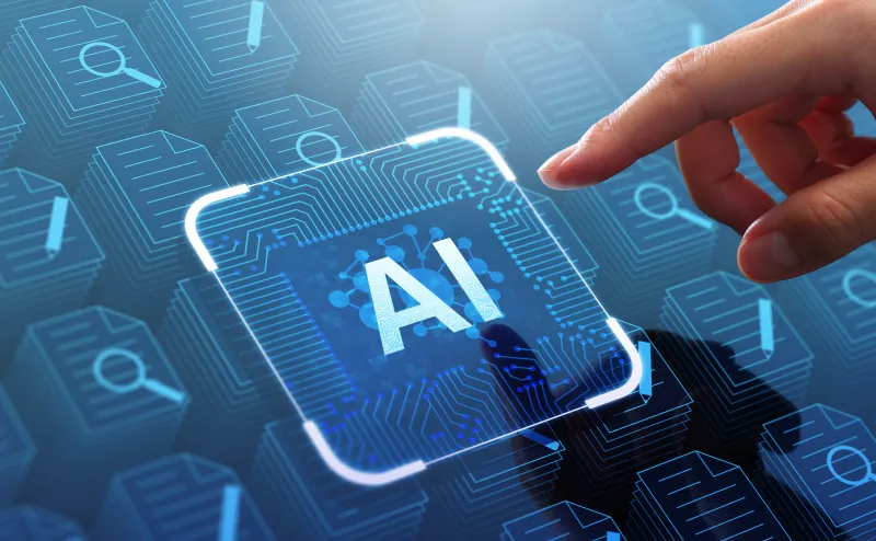 「AI」と表示されたチップのアイコンに指を伸ばす手